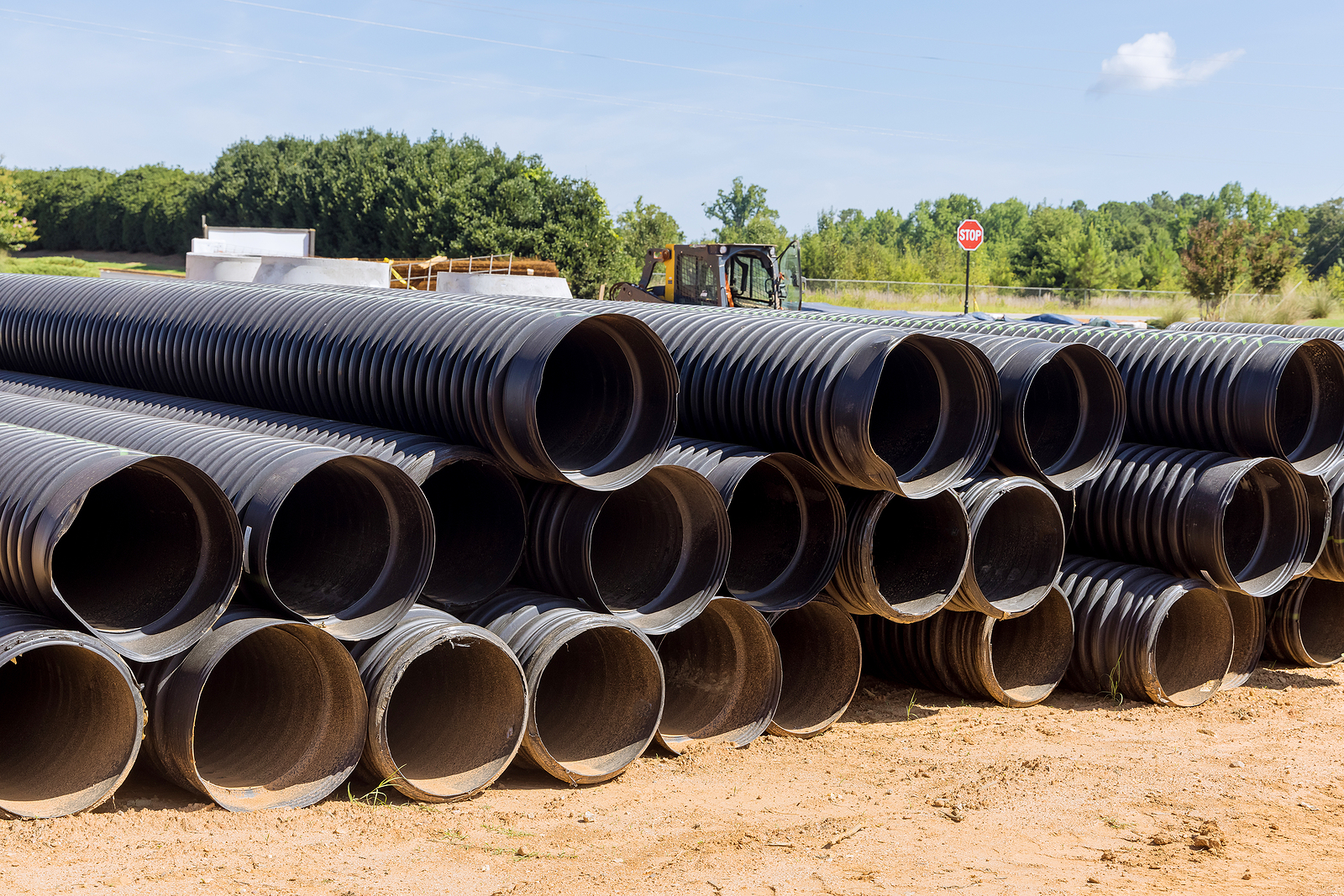 Construction Site, New Pvc Black Plastic Pipes Stacked In Rows A
